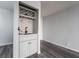 Chic wet bar area with patterned tile backsplash, gray wood floors, and modern fixtures at 745 N Royal Crest Cir # 141, Las Vegas, NV 89169