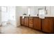 Bright bathroom offers a double vanity with wood cabinets, white counters, and tile floors at 7466 Matilda St, Las Vegas, NV 89113