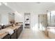 Bright primary bathroom with double sinks, glass shower, and a separate soaking tub at 7466 Matilda St, Las Vegas, NV 89113