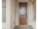 The gorgeous wood front door is part of the home's curb appeal at 7466 Matilda St, Las Vegas, NV 89113