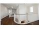 Upstairs hallway with hardwood flooring, white railings, and natural light at 7466 Matilda St, Las Vegas, NV 89113