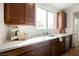 Bright kitchen featuring wood cabinets, stainless steel appliances, white countertops, and natural light at 7466 Matilda St, Las Vegas, NV 89113