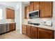 Spacious kitchen featuring wood cabinets, stainless steel appliances, white countertops, and tile flooring at 7466 Matilda St, Las Vegas, NV 89113