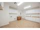 Spacious laundry room with tile floors, white cabinets, and a sink at 7466 Matilda St, Las Vegas, NV 89113