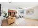 Well-lit living room with a ceiling fan, large windows, and built-in cabinets for storage at 7466 Matilda St, Las Vegas, NV 89113