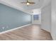 Bright, airy bedroom features modern ceiling fan and light wood-look floors at 75 E Agate Ave # 206, Las Vegas, NV 89123