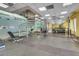 The gym features a spiral staircase, a mirrored wall, weight machines and dumbbell racks at 75 E Agate Ave # 206, Las Vegas, NV 89123