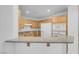 Eat-in kitchen featuring granite counters and wood cabinetry at 75 E Agate Ave # 206, Las Vegas, NV 89123