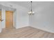 Living room with modern light fixture and wood-look floors at 75 E Agate Ave # 206, Las Vegas, NV 89123