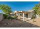 Private backyard with a covered patio and desert landscaping at 7754 Pink Ginger St, Las Vegas, NV 89123