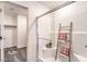 Bathroom featuring glass-enclosed shower with decorative ladder, white tiled walls, and neutral carpet in the walk-in closet at 790 Calm Crystal Ct # Lot 140, North Las Vegas, NV 89081