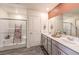 Bathroom featuring double sink vanity with gray cabinets, a large mirror, and a glass-enclosed shower with a decorative ladder at 790 Calm Crystal Ct # Lot 140, North Las Vegas, NV 89081