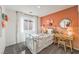 Bright bedroom with stylish decor, featuring a twin bed, desk with chair, and large windows with curtains at 790 Calm Crystal Ct # Lot 140, North Las Vegas, NV 89081