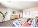 Bright bedroom featuring neutral-toned walls, patterned bedding, light wood dresser, and soft, natural light at 790 Calm Crystal Ct # Lot 140, North Las Vegas, NV 89081