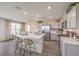 Bright kitchen boasts a large island with seating and stainless steel appliances at 790 Calm Crystal Ct # Lot 140, North Las Vegas, NV 89081