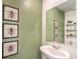 Stylish powder room features modern fixtures and unique decor with bee artwork at 790 Calm Crystal Ct # Lot 140, North Las Vegas, NV 89081