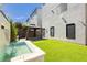 Backyard with small pool, an artificial lawn, and an outdoor gazebo sitting area at 8095 Carpenter Creek Ave, Las Vegas, NV 89113