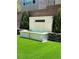 Backyard with a stone fountain, artificial turf, and landscaped surroundings at 8095 Carpenter Creek Ave, Las Vegas, NV 89113