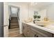 Upstairs bathroom featuring dual sinks, marble countertops and an entrance to staircase at 8095 Carpenter Creek Ave, Las Vegas, NV 89113
