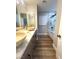 Bathroom with dual sinks, marble countertop, and a glass-enclosed shower at 8095 Carpenter Creek Ave, Las Vegas, NV 89113