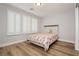 Cozy bedroom featuring wood floors and windows with modern shutters at 8095 Carpenter Creek Ave, Las Vegas, NV 89113