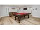 Large billiards table is the focal point in this game room with stylish flooring and a comfortable leather sofa at 8095 Carpenter Creek Ave, Las Vegas, NV 89113