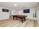 Spacious game room with a billiards table, television, recessed lighting, and sleek wood-look flooring at 8095 Carpenter Creek Ave, Las Vegas, NV 89113