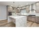 Bright kitchen with a marble island, stainless steel appliances, and shaker cabinets at 8095 Carpenter Creek Ave, Las Vegas, NV 89113