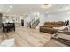 Open concept living room area with stairs and a modern kitchen at 8095 Carpenter Creek Ave, Las Vegas, NV 89113