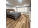 Bedroom with a large bed, neutral walls, and natural light from shuttered windows at 8095 Carpenter Creek Ave, Las Vegas, NV 89113