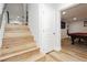 Bright stairway featuring wood steps leading to a recreational room with a billiards table and a mounted television at 8095 Carpenter Creek Ave, Las Vegas, NV 89113