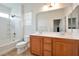 Bright bathroom featuring a double sink vanity, soaking tub with shower, and neutral tile flooring at 8152 Satin Carnation Ln, Las Vegas, NV 89166