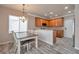 Bright and sunny kitchen featuring a dining table, stainless steel appliances, and wood-look tile flooring at 8152 Satin Carnation Ln, Las Vegas, NV 89166