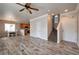 Open-concept living space showcasing wood-look flooring, a dining area, staircase and adjacent kitchen at 8152 Satin Carnation Ln, Las Vegas, NV 89166