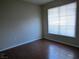 A simple bedroom featuring hardwood floors, neutral walls, and a bright window at 9000 Las Vegas Blvd # 1250, Las Vegas, NV 89123