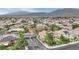 Community aerial view showcasing a well-planned neighborhood with tree-lined streets and stunning mountain views at 9046 Barium Rock Ave, Las Vegas, NV 89143