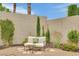 Cozy backyard nook features comfortable seating surrounded by mature trees and blooming flowers at 9046 Barium Rock Ave, Las Vegas, NV 89143