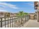 Balcony features palm trees and views of the neighborhood on a clear day with blue skies at 9046 Barium Rock Ave, Las Vegas, NV 89143