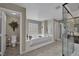 A spacious bathroom with a relaxing tub, shower, and toilet at 9046 Barium Rock Ave, Las Vegas, NV 89143