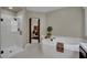 Bright bathroom featuring a soaking tub, step-in shower and neutral toned walls at 9046 Barium Rock Ave, Las Vegas, NV 89143