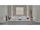 This soaking tub has a decorative tile surround with a glass block window at 9046 Barium Rock Ave, Las Vegas, NV 89143