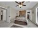 Cozy bedroom features a ceiling fan, a large bed, and a glass door to the outdoor area at 9046 Barium Rock Ave, Las Vegas, NV 89143