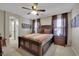 Spacious bedroom features a ceiling fan, a large bed with matching nightstands and decorative art at 9046 Barium Rock Ave, Las Vegas, NV 89143
