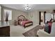 A staged bedroom featuring a carpet, bed and ensuite bathroom at 9046 Barium Rock Ave, Las Vegas, NV 89143