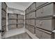 Walk-in closet featuring organized storage with multiple fabric storage boxes on white shelving at 9046 Barium Rock Ave, Las Vegas, NV 89143