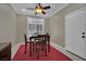 This dining area features a ceiling fan and a red rug at 9046 Barium Rock Ave, Las Vegas, NV 89143