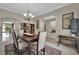 Formal dining room with a dark wood table, light-colored chairs, and arched doorways at 9046 Barium Rock Ave, Las Vegas, NV 89143
