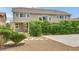 Lovely house exterior with lush greenery, a private patio, and a paved driveway at 9046 Barium Rock Ave, Las Vegas, NV 89143
