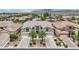 Stunning aerial view of a luxurious home with a well-manicured lawn, a circular driveway, and multiple garages at 9046 Barium Rock Ave, Las Vegas, NV 89143