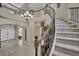Stunning foyer features a curved staircase, tile flooring, a chandelier and an open layout at 9046 Barium Rock Ave, Las Vegas, NV 89143